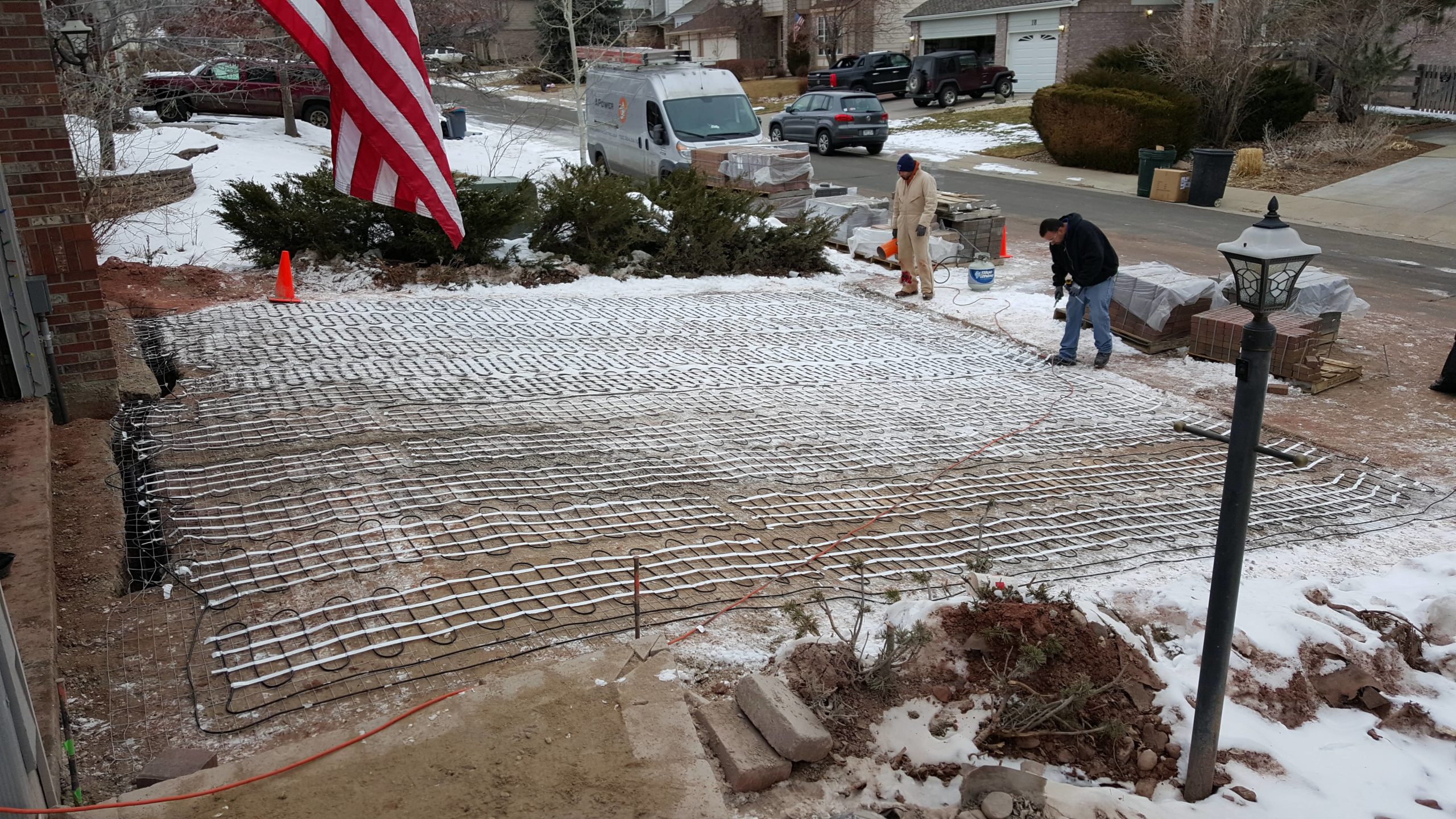 electricians installing heated floors on a driveway