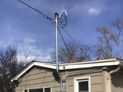 installation of electrical mast in front of a house
